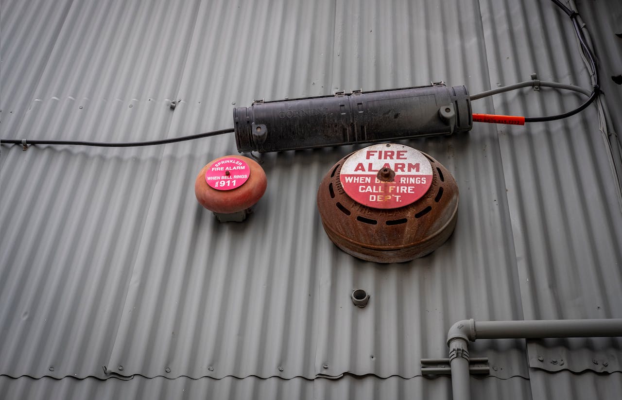 The Art of Drawing Readers In: Your attractive post title goes here An industrial fire alarm system mounted on a corrugated metal wall for safety and security.